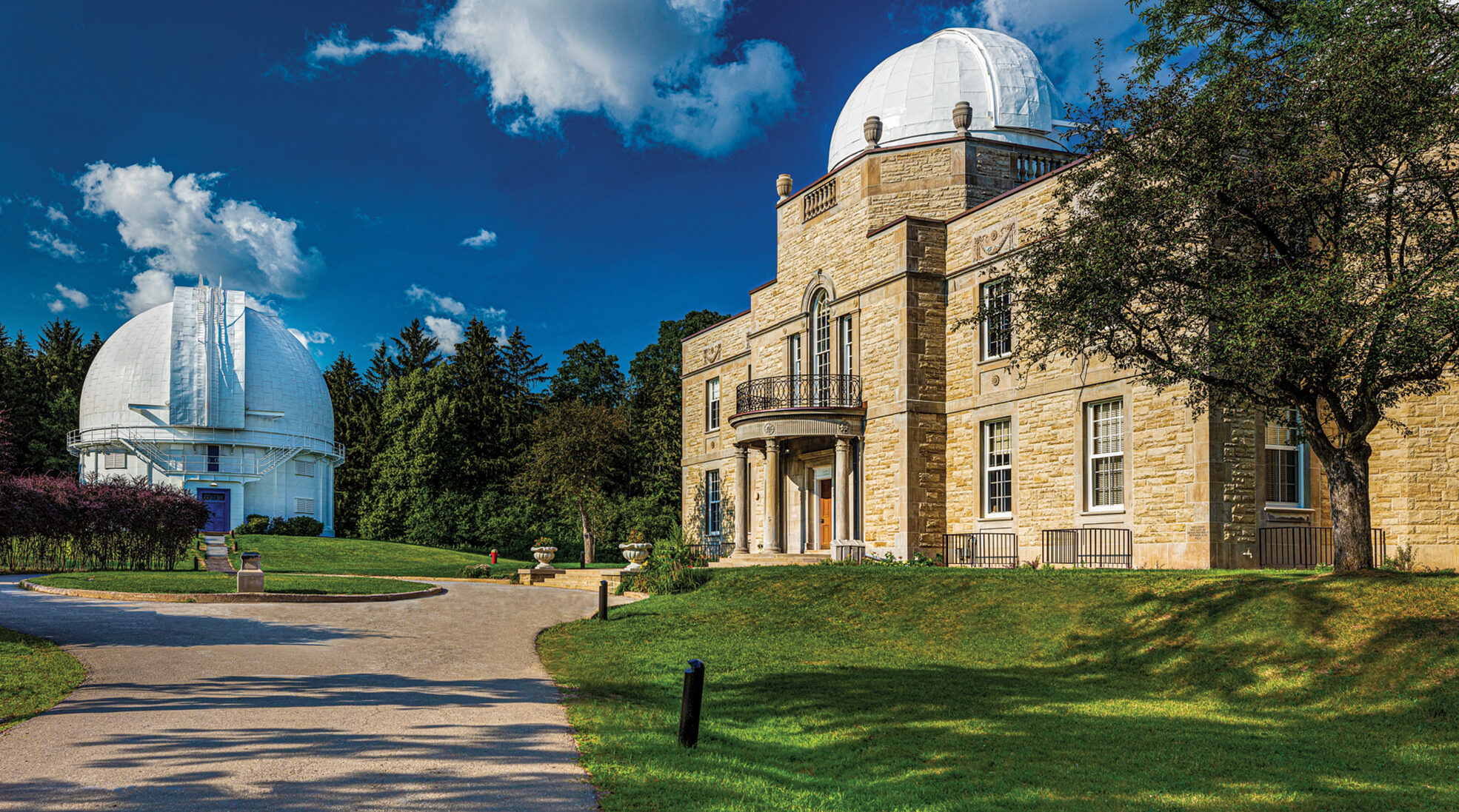 View of Observatory on left and Administration Building on right from down entry lane on a sunny day